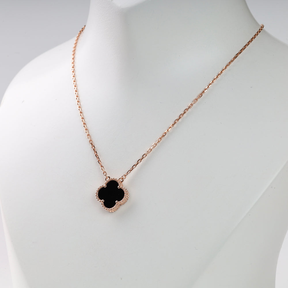 Rose gold chain necklace with a black quatrefoil pendant on display, minimalist jewelry, clover necklace, gift for her.