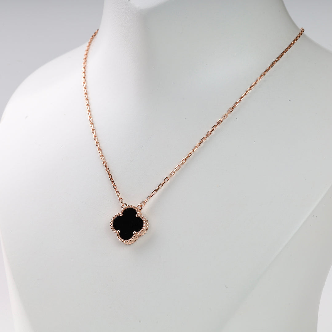 Rose gold chain necklace with a black quatrefoil pendant on display, minimalist jewelry, clover necklace, gift for her.
