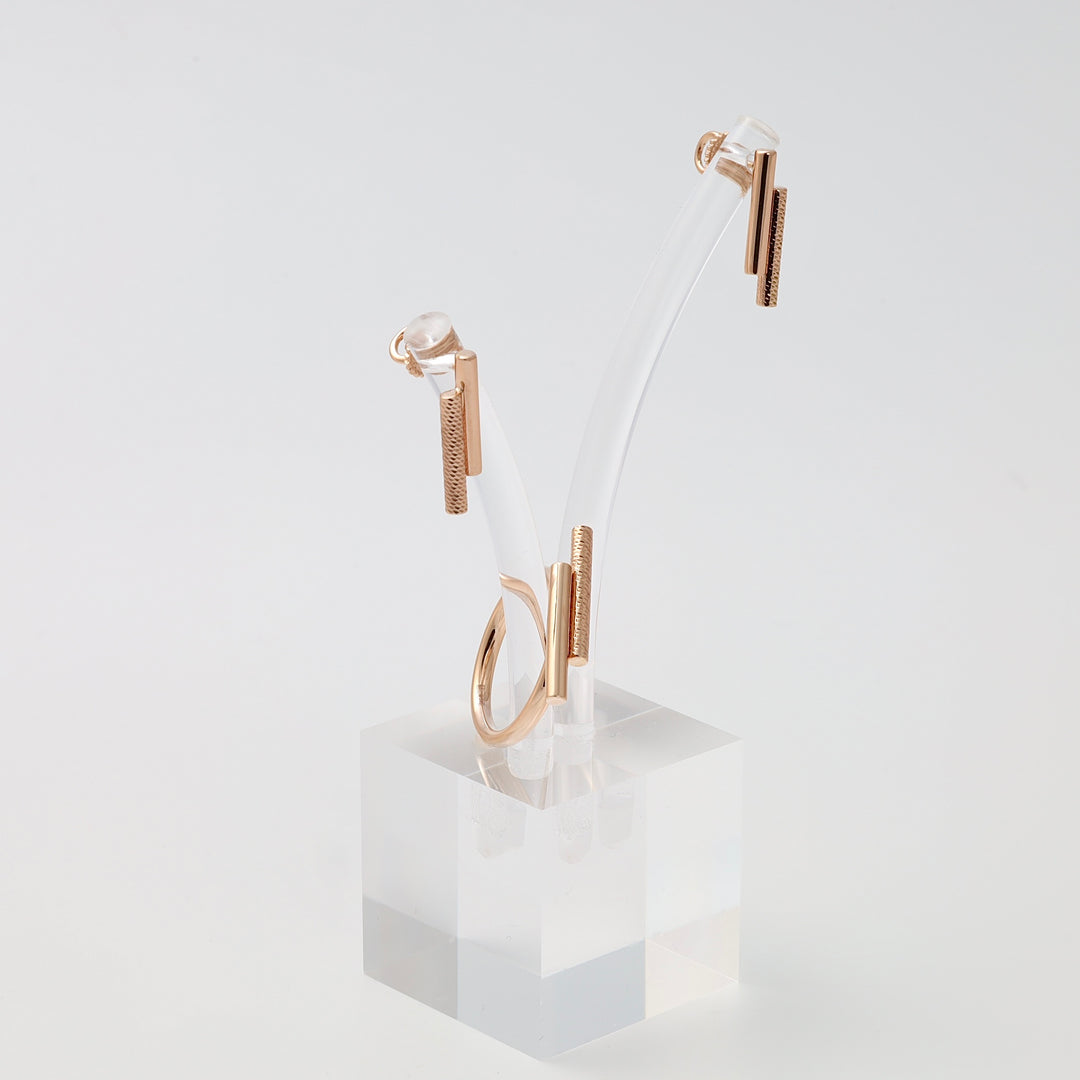 Minimalist rose gold ring and bar earrings set on clear stand, 14k gold Ukrainian Jewelry, modern gold ring and dangle earrings.