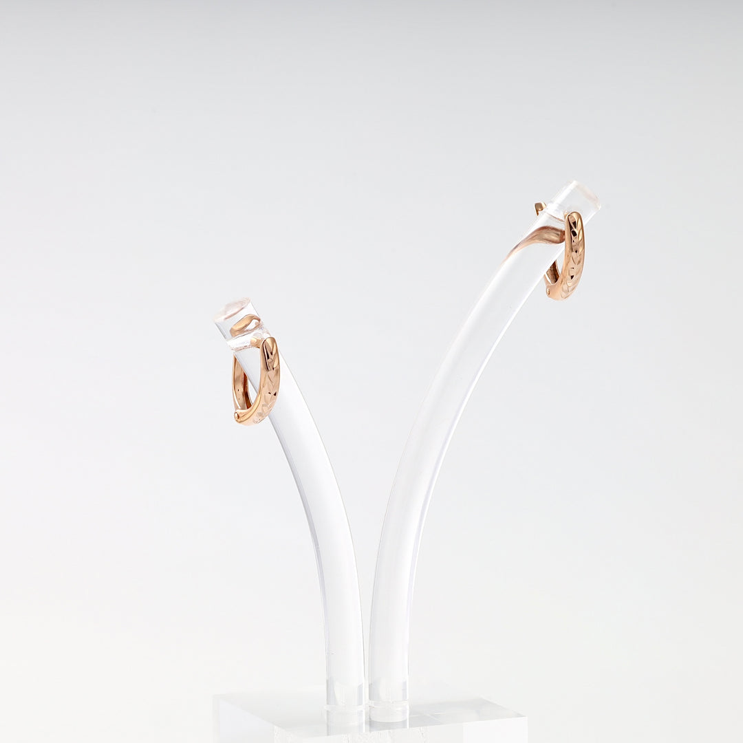 Small 14k gold hoop earrings with engraved leaf pattern on stand, Ukrainian Jewelry, minimalist gold huggie hoops for women.