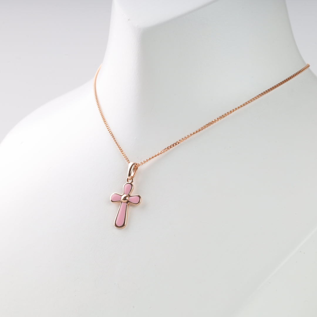 Rose gold chain necklace with a pink enamel cross pendant displayed on a white bust. Cross necklace, pink enamel jewelry.