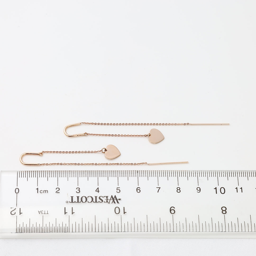14k gold threader earrings with heart charms on fine chain, displayed beside a ruler, dainty Ukrainian Jewelry gift.