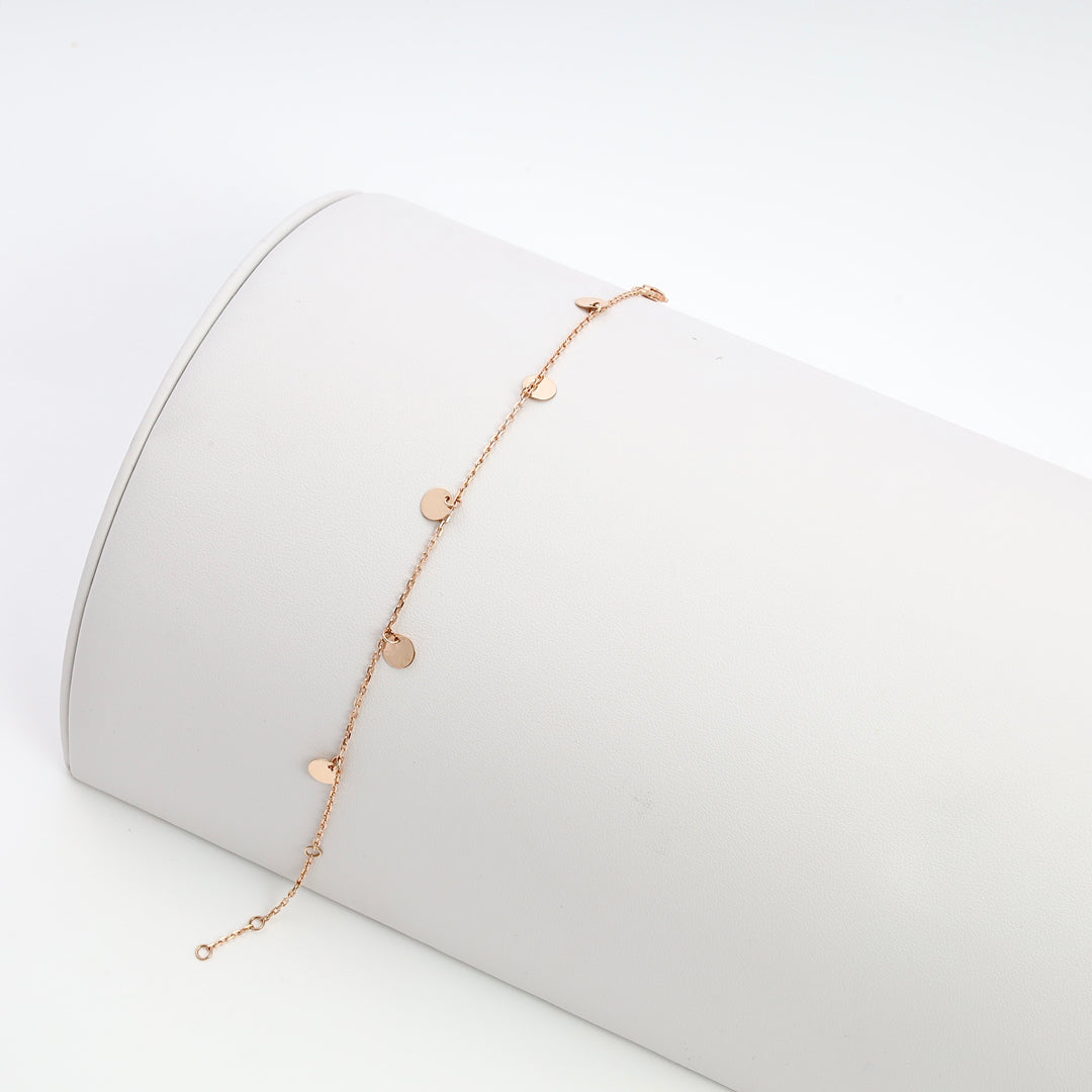 Delicate 14k gold bracelet with small heart charms on chain, displayed on white roll, Ukrainian Jewelry, gold heart bracelet gift.