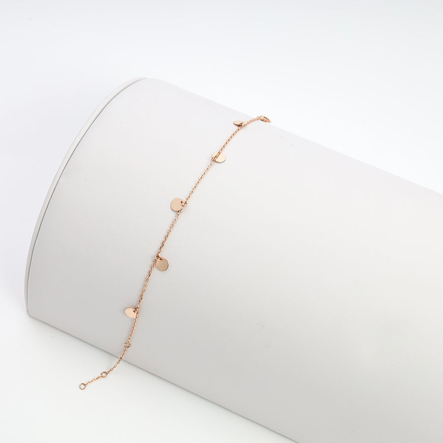 Delicate 14k gold bracelet with small heart charms on chain, displayed on white roll, Ukrainian Jewelry, gold heart bracelet gift.