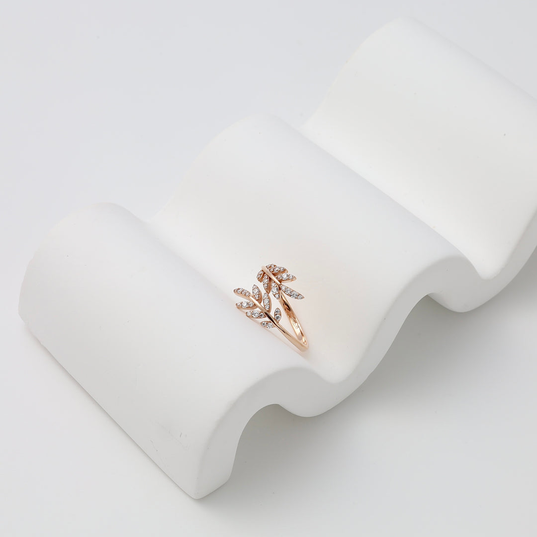 Rose gold ring with cubic zirconia leaf design on white display, 14k gold leaf ring Ukrainian Jewelry, dainty stacking ring.