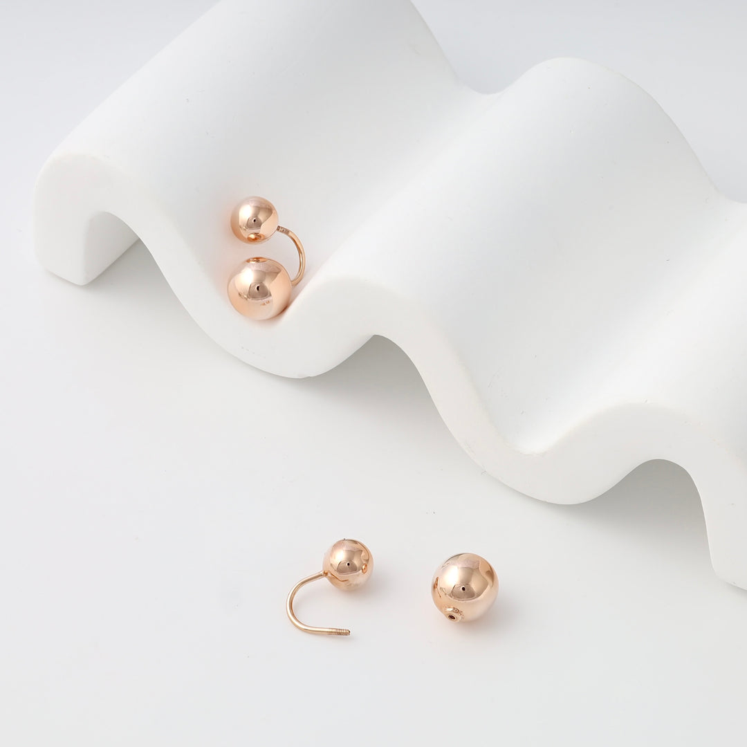 Rose gold ball stud earrings in 14k gold, minimalist sphere design on white display, Ukrainian Jewelry, simple gold earrings gift.