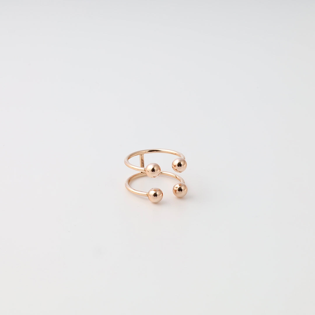 14k gold open band ring with three sphere accents on white background, minimalist stackable Ukrainian Jewelry, modern gold ring.