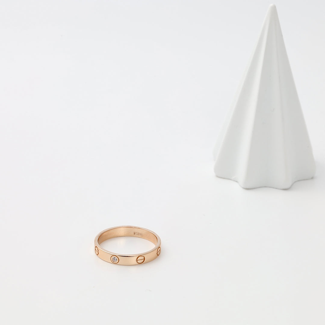 14k gold band ring with screw motif and small diamond set on white display, Ukrainian Jewelry, minimalist gold ring gift.