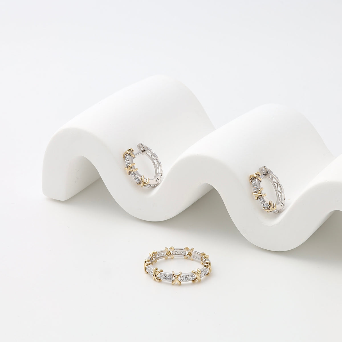 Sterling silver and gold hoop earrings with crystal stones on a white display, Ukrainian Jewelry, delicate mixed metal hoop earrings.