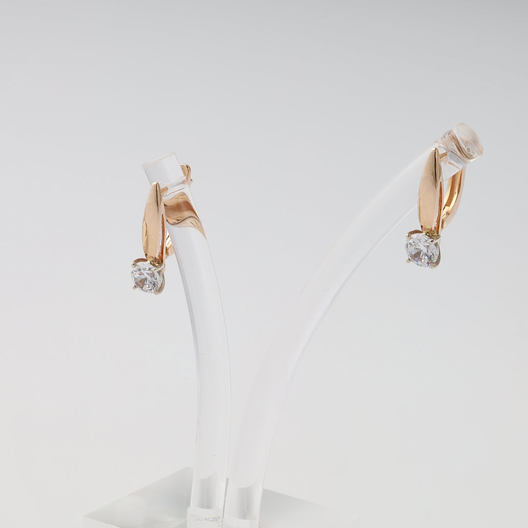 Pair of 14k gold drop earrings with clear gemstone solitaire dangles on a stand, Ukrainian Jewelry, minimalist gold earrings.