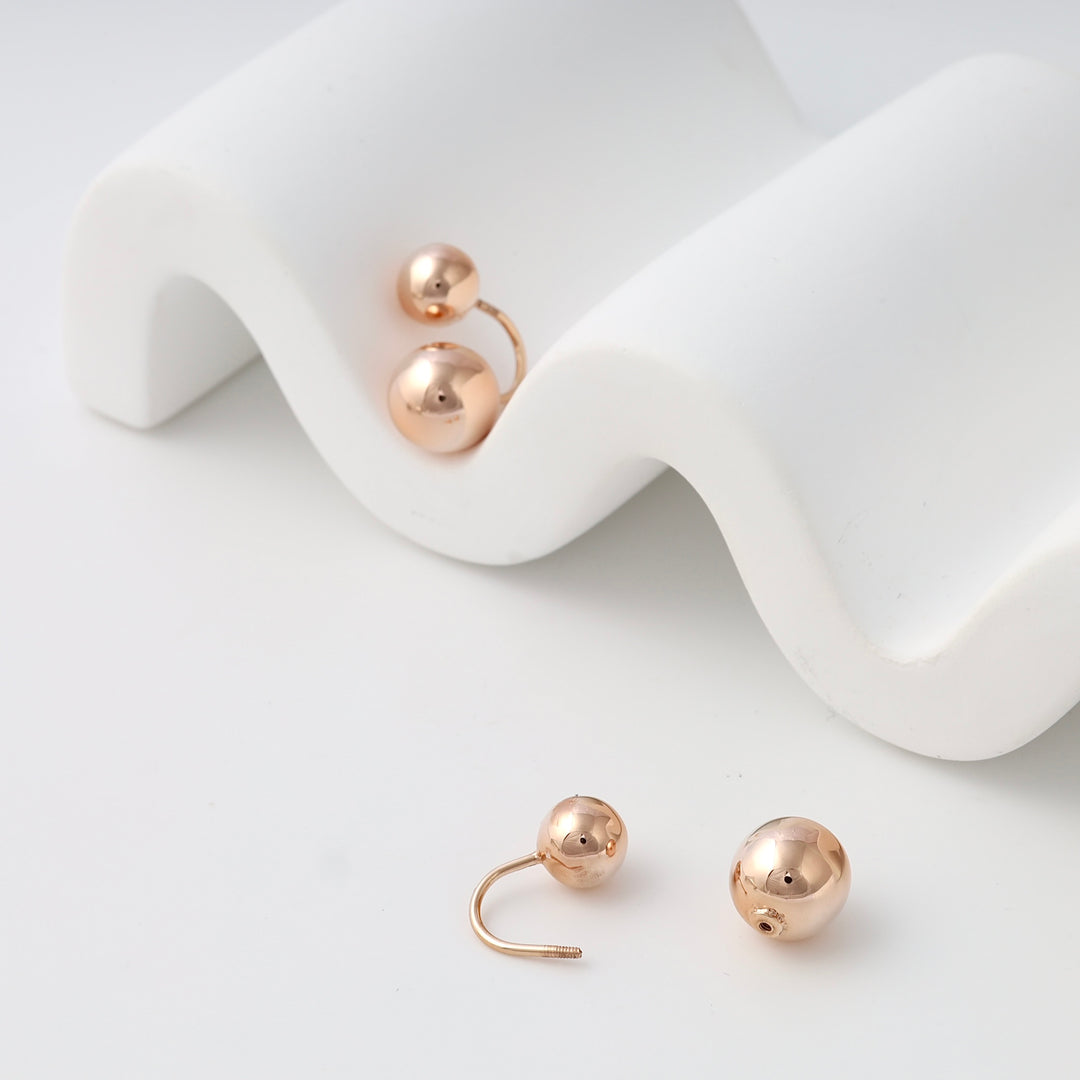 Rose gold 14k gold ball screw back earrings on white display, minimalist stud Ukrainian Jewelry for everyday wear.