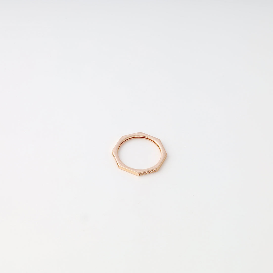 Single 14k gold hexagon stacking ring with tiny stones on a white background, minimalist Ukrainian Jewelry, delicate gold ring.