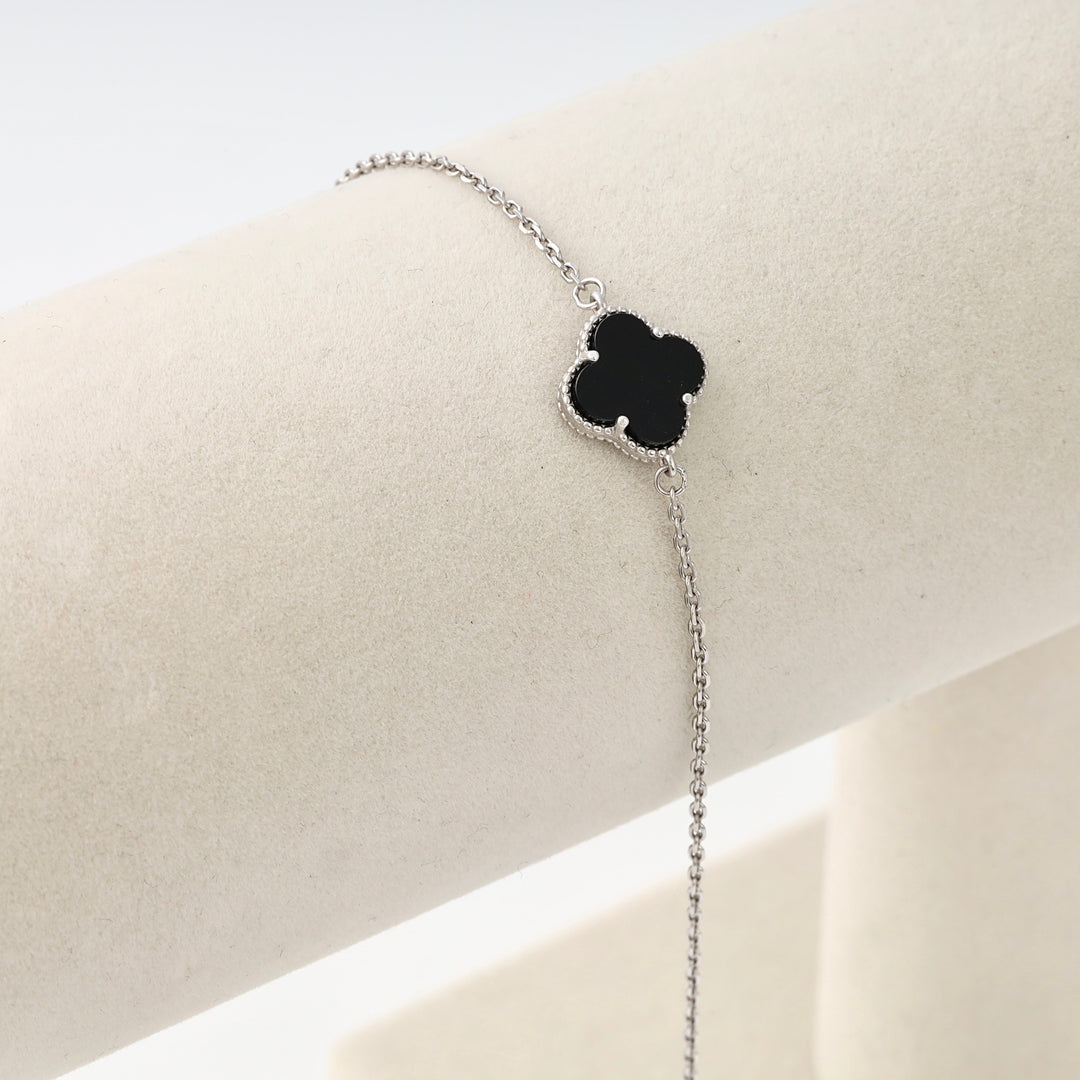 Sterling silver bracelet with black clover charm on display stand, Ukrainian Jewelry, dainty silver chain, minimalist bracelet.