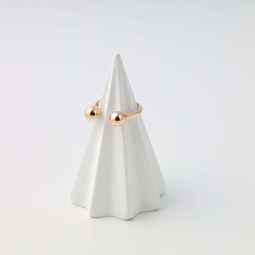 Minimalist 14k gold open ring with two ball ends on a white stand, modern Ukrainian Jewelry, simple gold stacking ring.