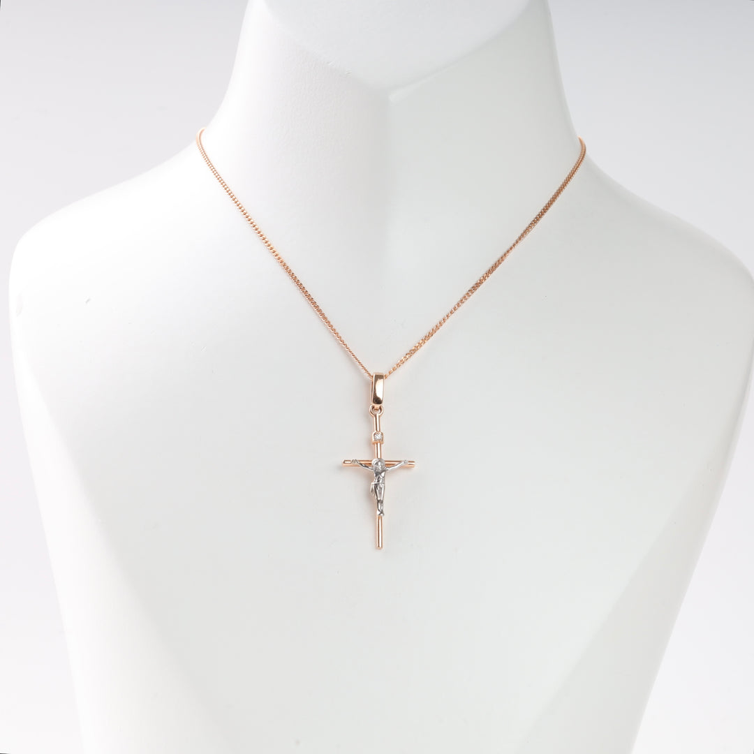 Gold chain necklace with two-tone crucifix pendant displayed on a white bust, religious jewelry, cross necklace, Christian gift.