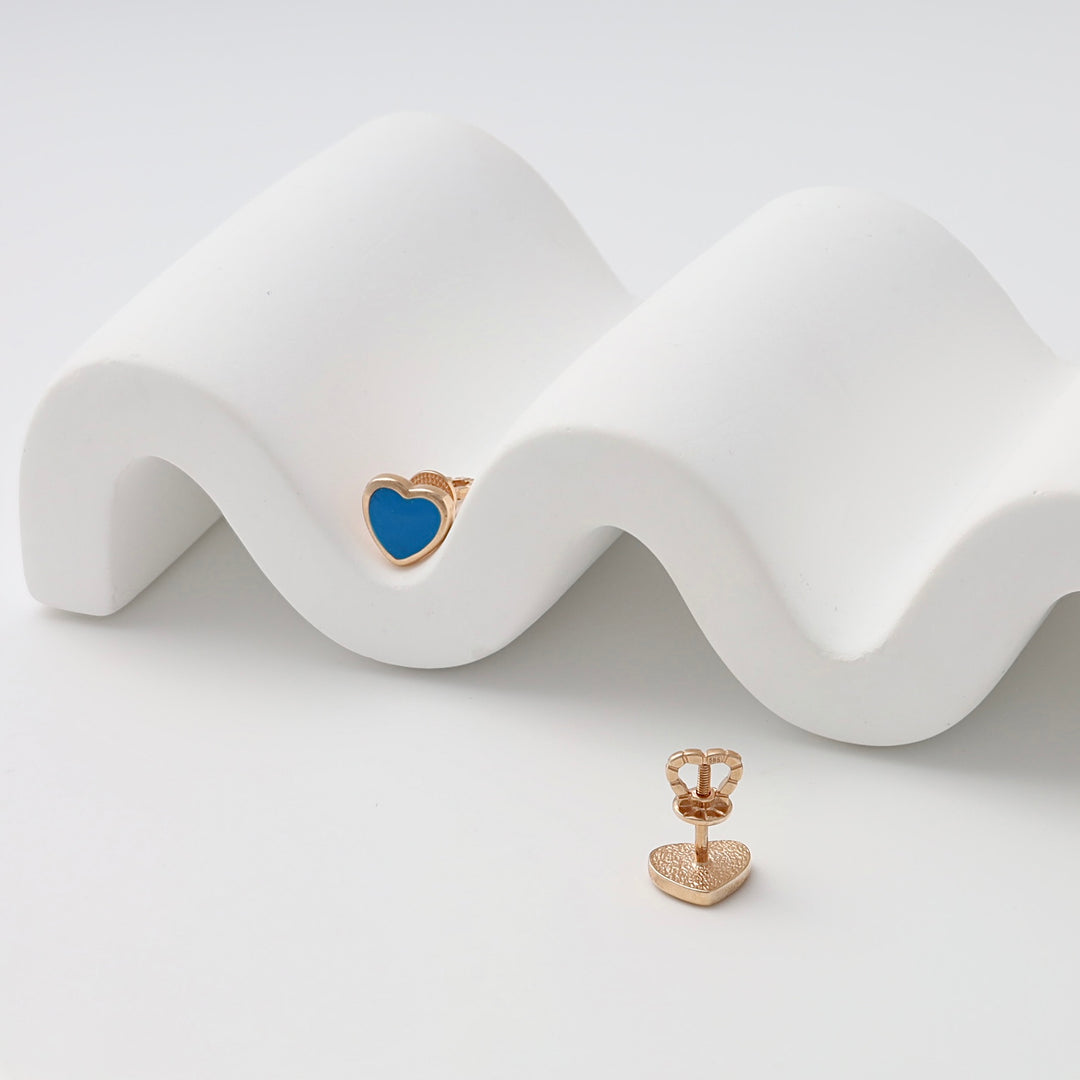 Gold heart stud earrings with blue enamel, showcased on white display, Ukrainian Jewelry, dainty gold heart earrings gift.