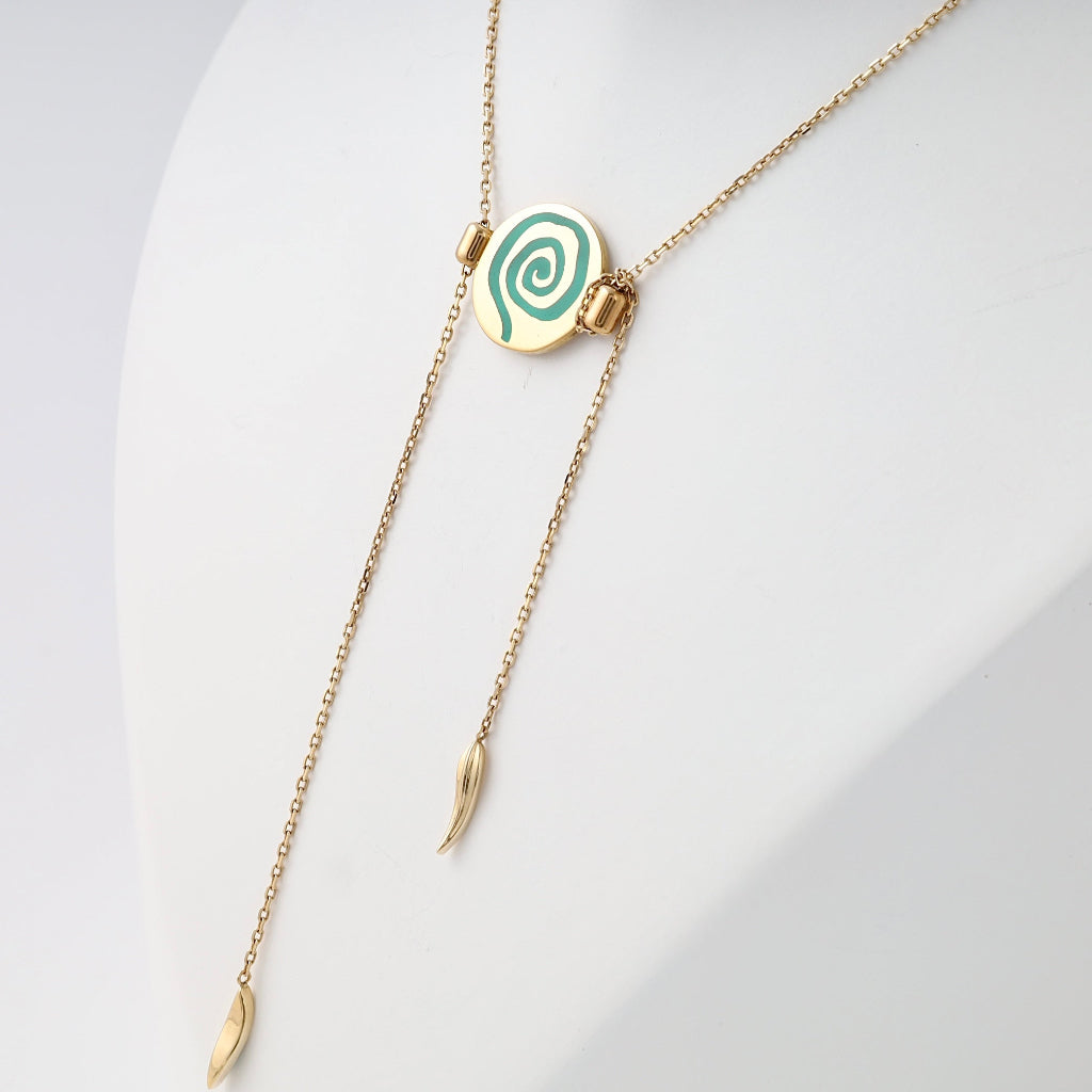Gold lariat necklace with green spiral pendant and leaf drops on display bust, 14k gold Ukrainian Jewelry, minimalist gold pendant necklace.