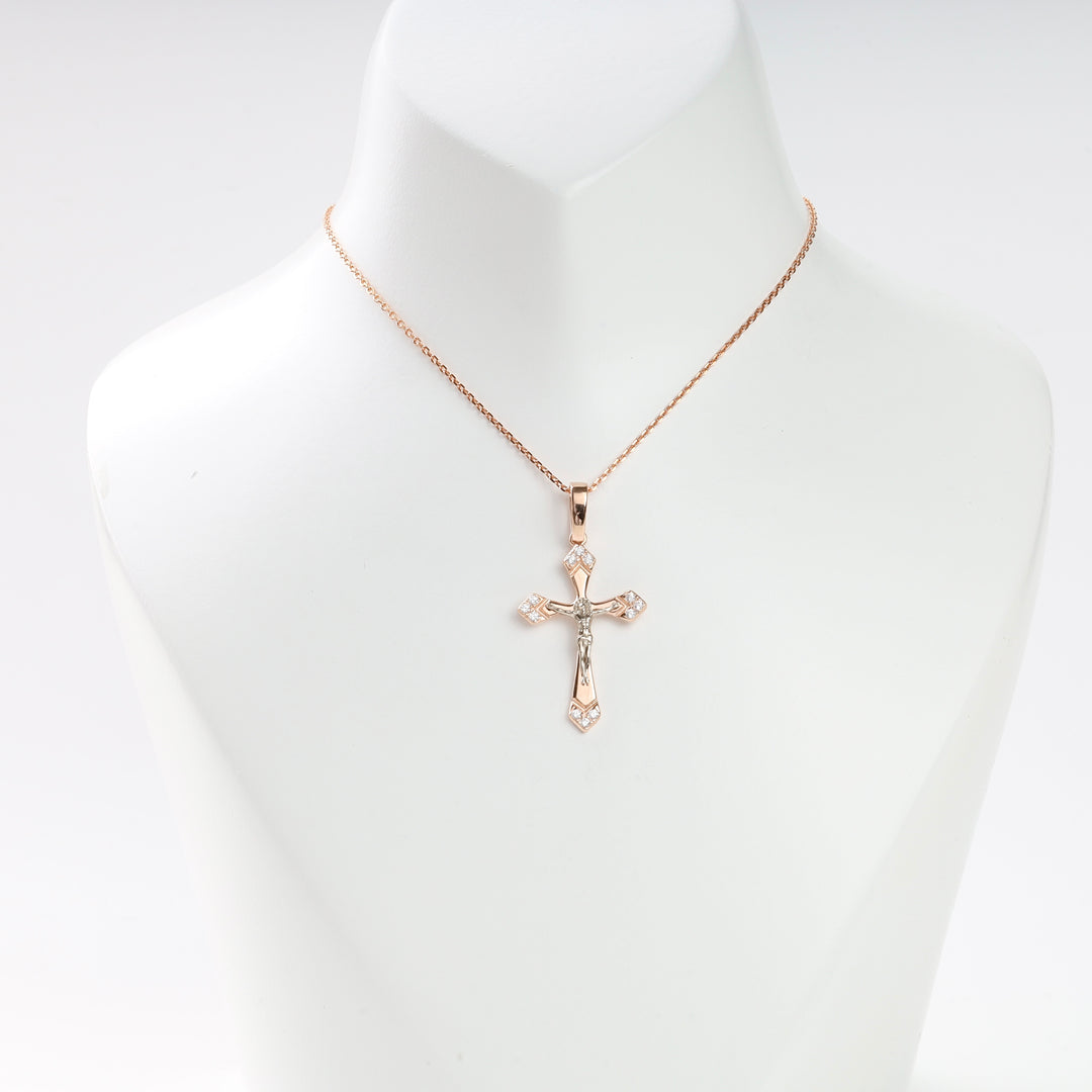 Rose gold chain necklace with a two-tone crucifix cross pendant displayed on a white bust.