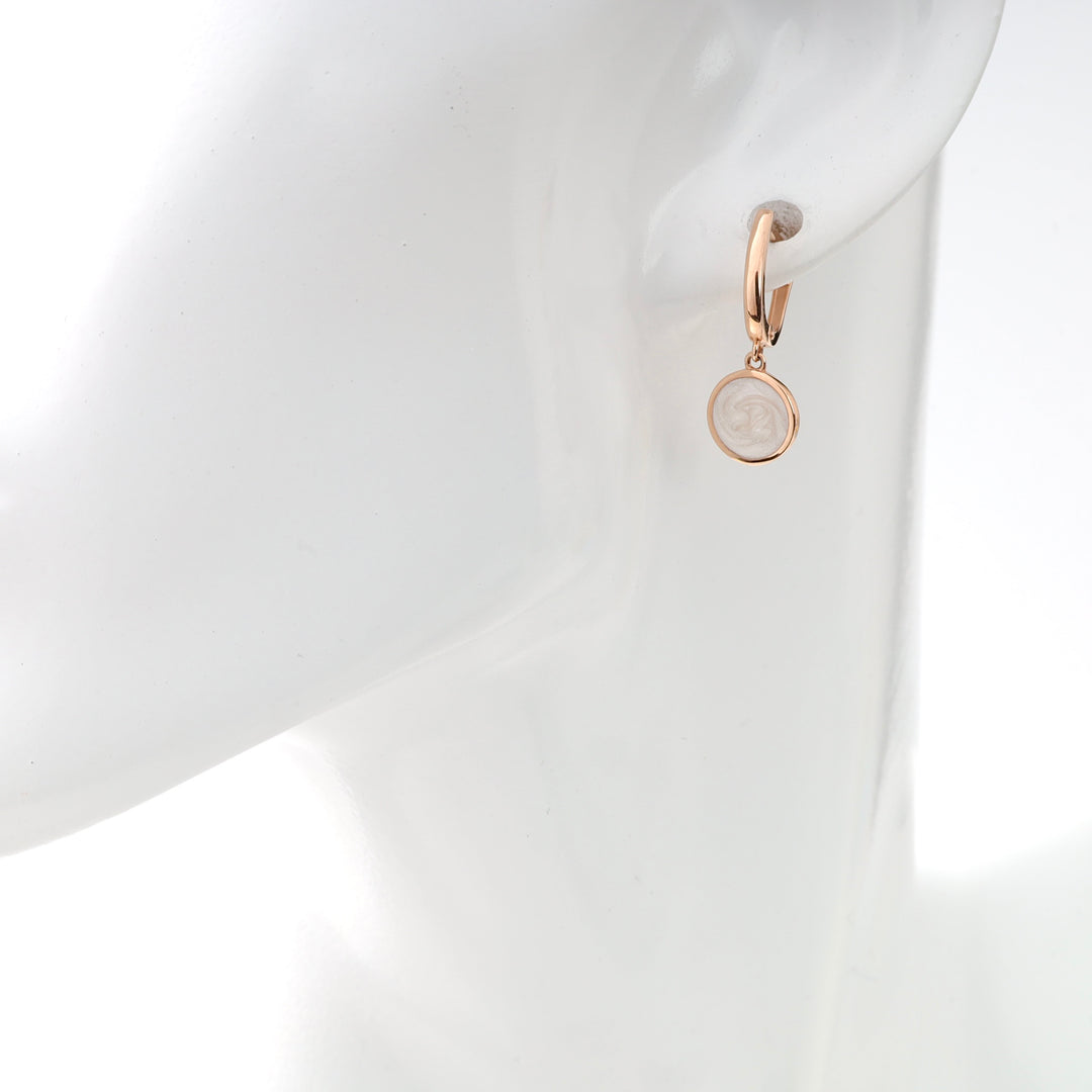 Rose gold hoop earrings with pearl-like cameo charm, displayed on a mannequin.