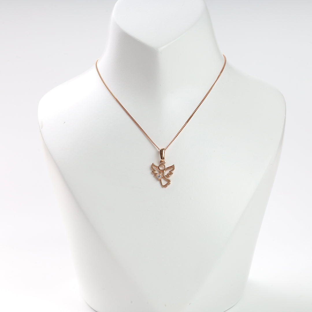 Rose gold angel pendant necklace with a clear gemstone, displayed on a white stand for jewelry, charm necklace.
