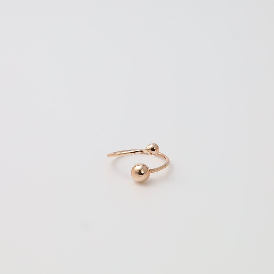Minimalist 14k gold open ring with two polished ball ends on white background, modern stackable Ukrainian Jewelry gift.