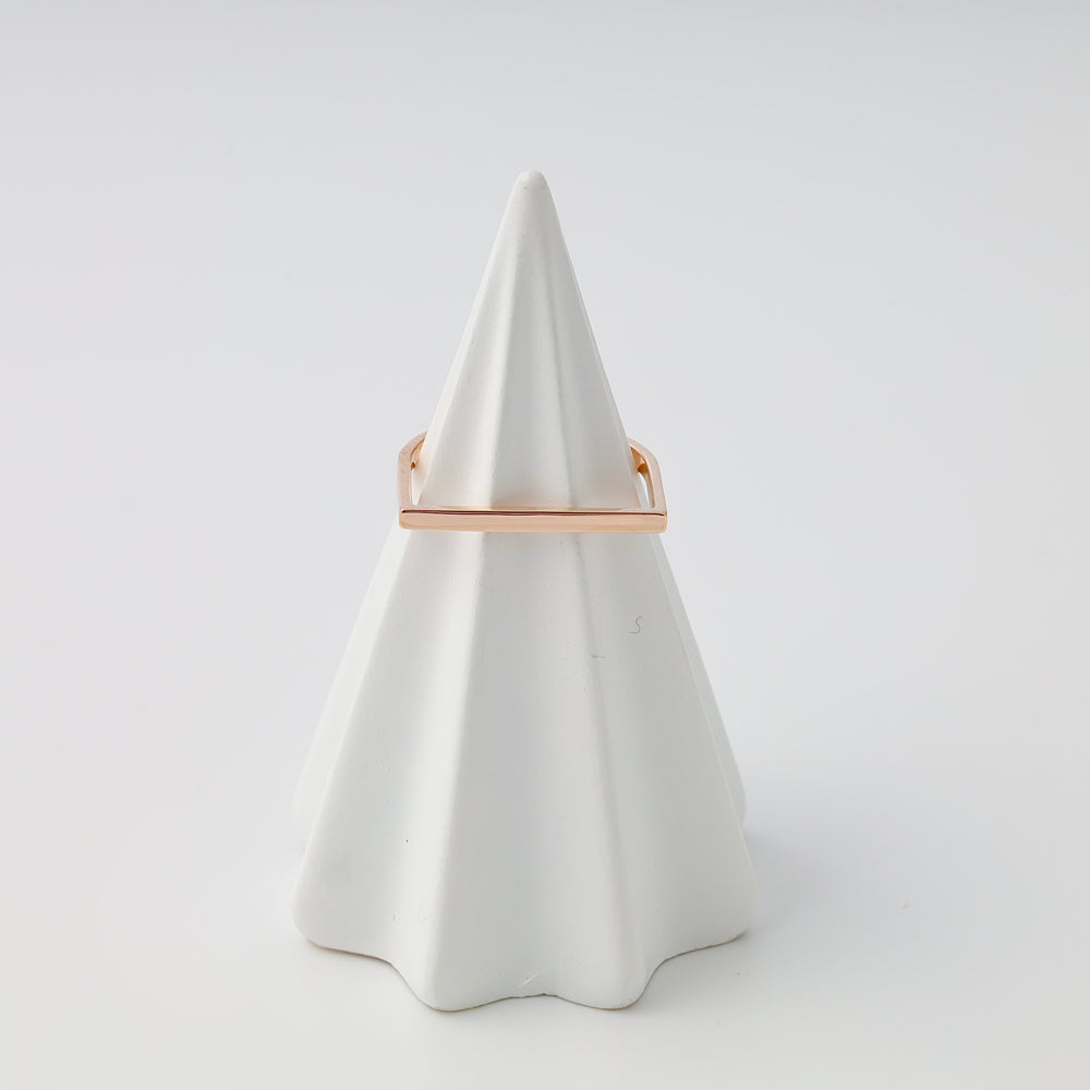 14k gold minimalist bar ring displayed on white cone stand, modern stacking ring Ukrainian Jewelry for women.