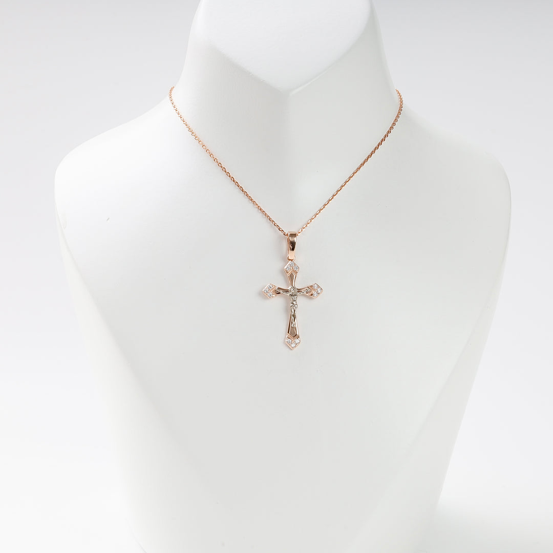 Rose gold cross pendant necklace with diamond accents displayed on a white mannequin.