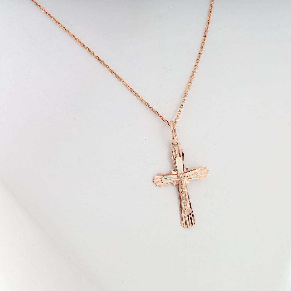 Rose gold cross pendant necklace with Jesus motif displayed on a white bust, religious jewelry, Christian gift.