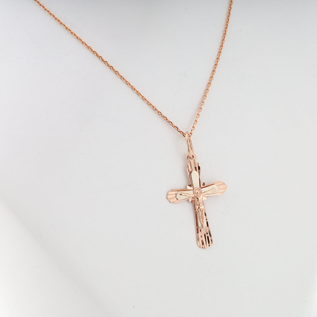 Rose gold cross pendant necklace with Jesus motif displayed on a white bust, religious jewelry, Christian gift.