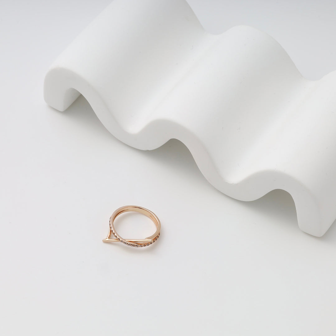 Delicate 14k gold ring with small clear stones displayed on white stand, minimalist Ukrainian Jewelry, dainty gold stacking ring.