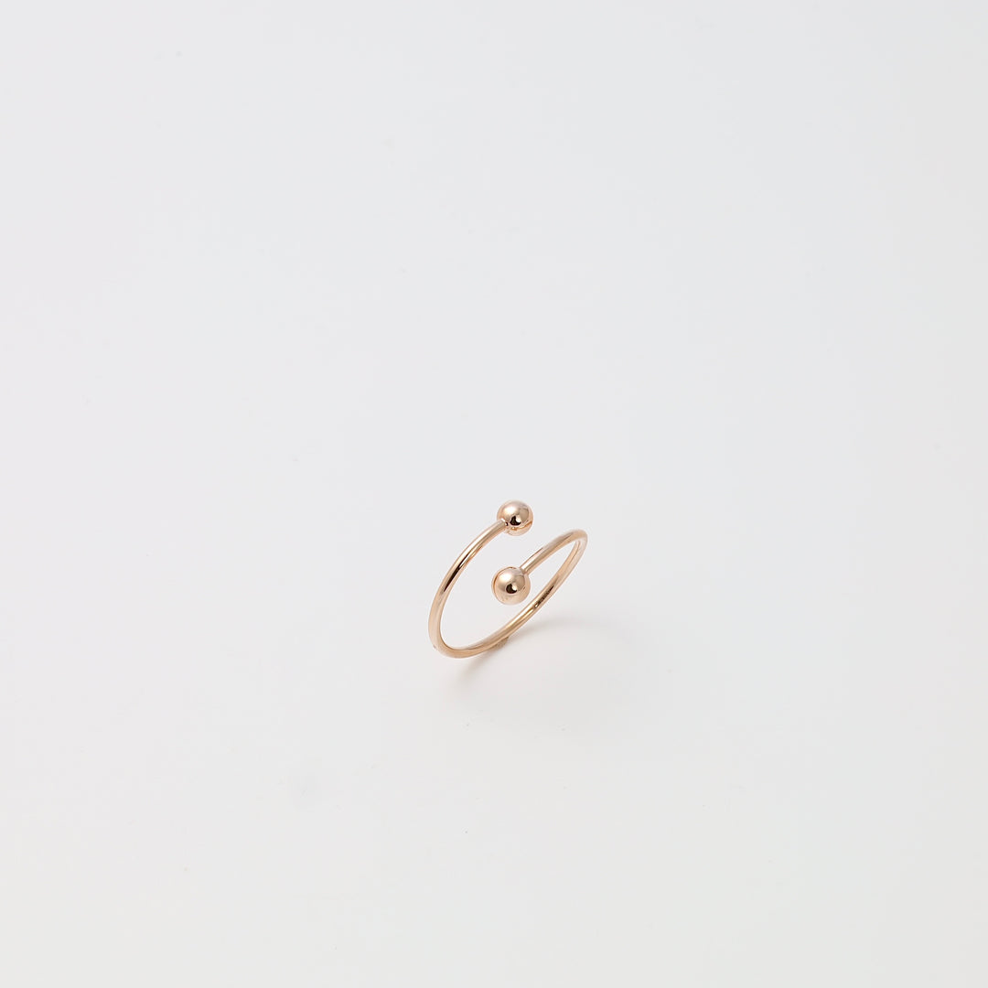 Minimalist 14k gold open band ring with two ball ends on white background, modern Ukrainian Jewelry, gold stacking ring gift.