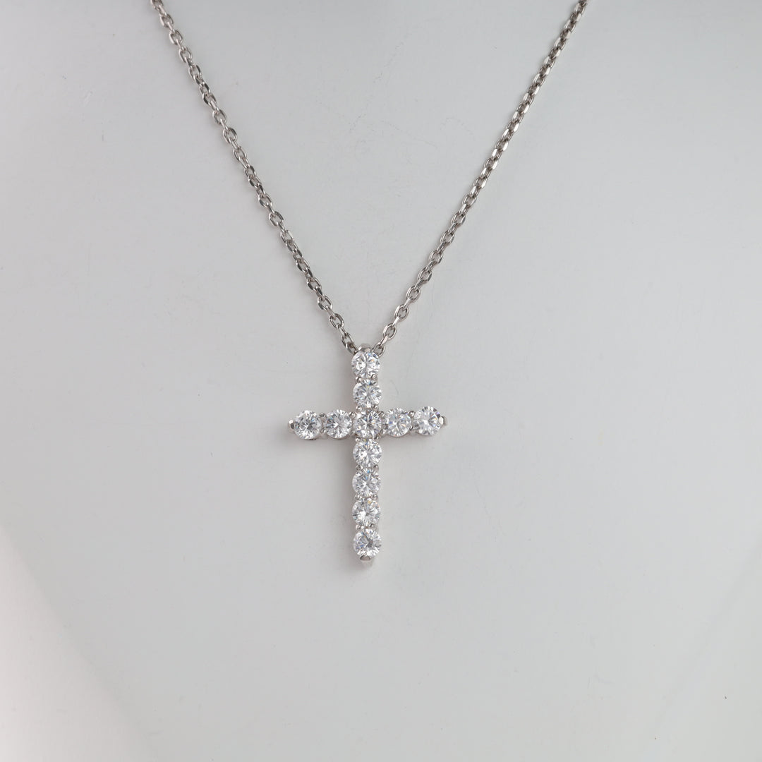 Diamond cross pendant on a silver chain necklace.