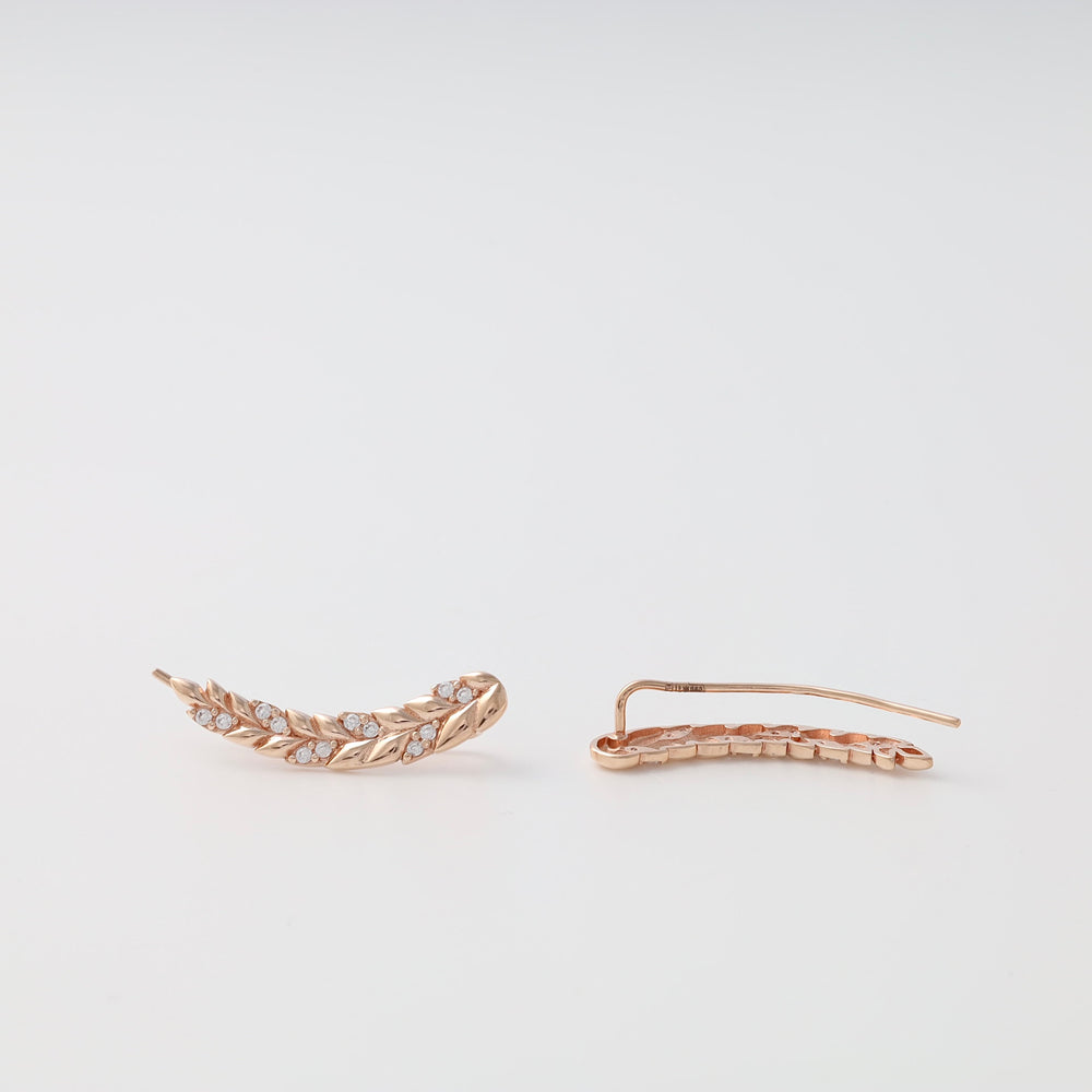 Rose gold leaf climber earrings with small clear crystals, displayed as a pair on a white background.