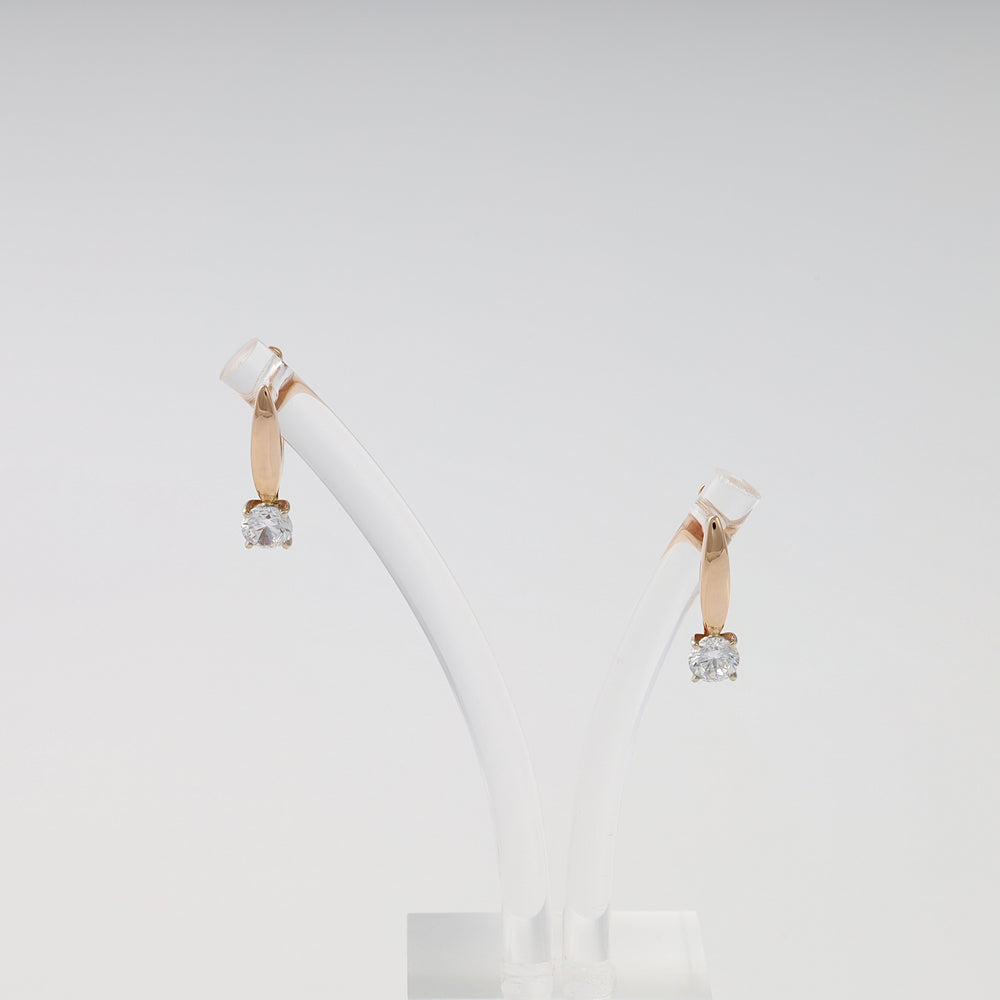 14k gold drop earrings with solitaire clear stones displayed on a stand, classic Ukrainian Jewelry for everyday gold earrings shoppers.