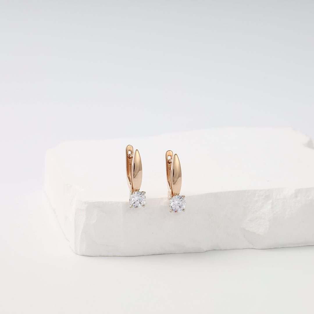 14k gold drop earrings with round clear stones on white display, Ukrainian Jewelry for minimalist gold dangle earrings shoppers.