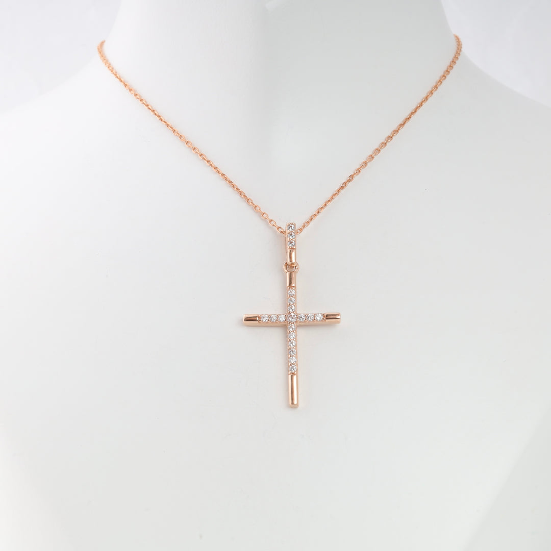 Rose gold chain necklace with a cubic zirconia cross pendant displayed on a white bust, religious jewelry, cross necklace.