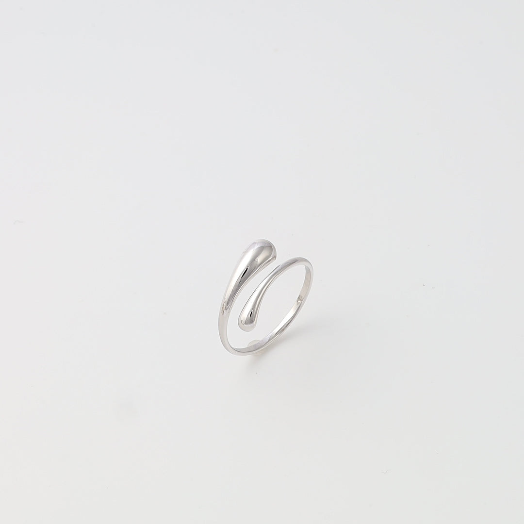 Sterling silver open wrap ring with teardrop ends on white background, minimalist Ukrainian Jewelry, silver statement ring.