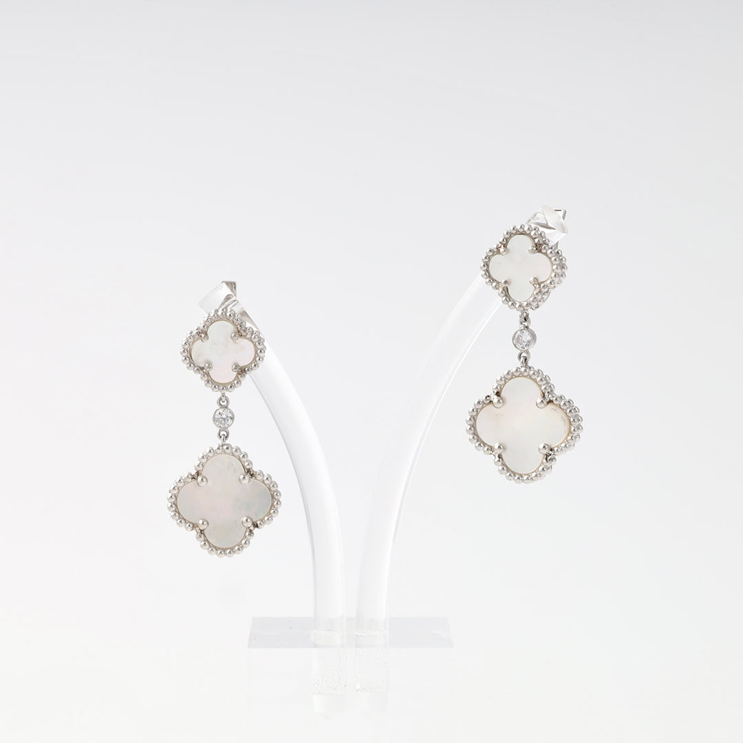 Sterling silver drop earrings with white clover motifs on a stand, Ukrainian Jewelry, perfect for dangle earring and gift search.