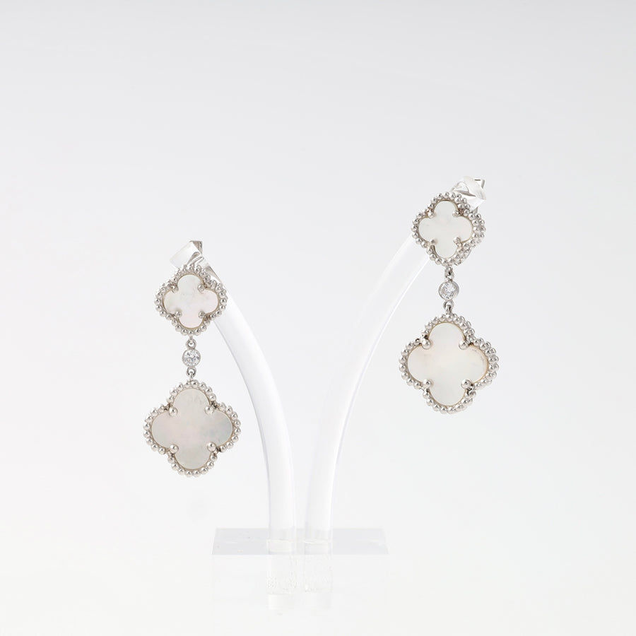 Sterling silver drop earrings with white clover motifs on a stand, Ukrainian Jewelry, perfect for dangle earring and gift search.