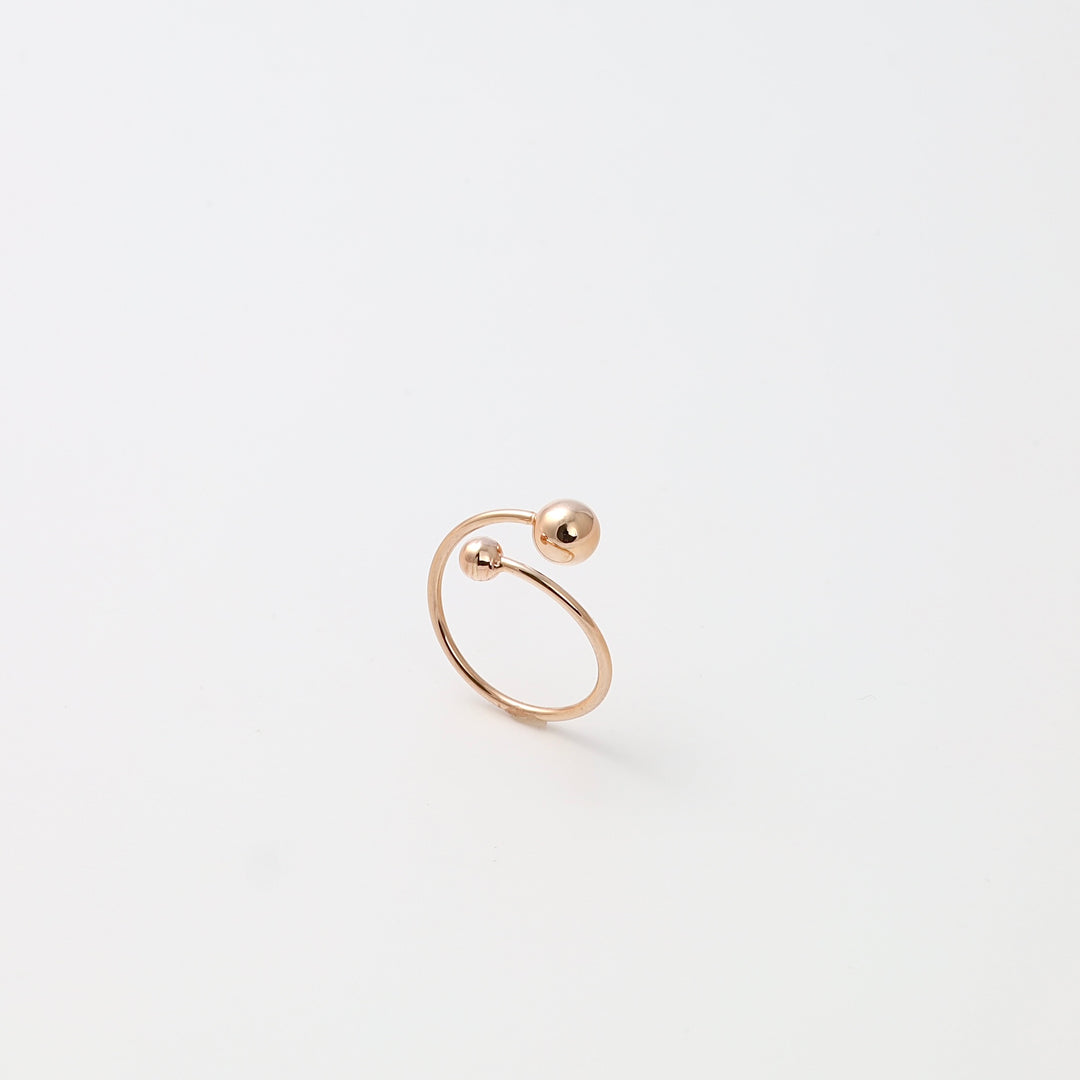 Minimalist 14k gold open ring with two ball ends on white background, modern stackable Ukrainian Jewelry for women.