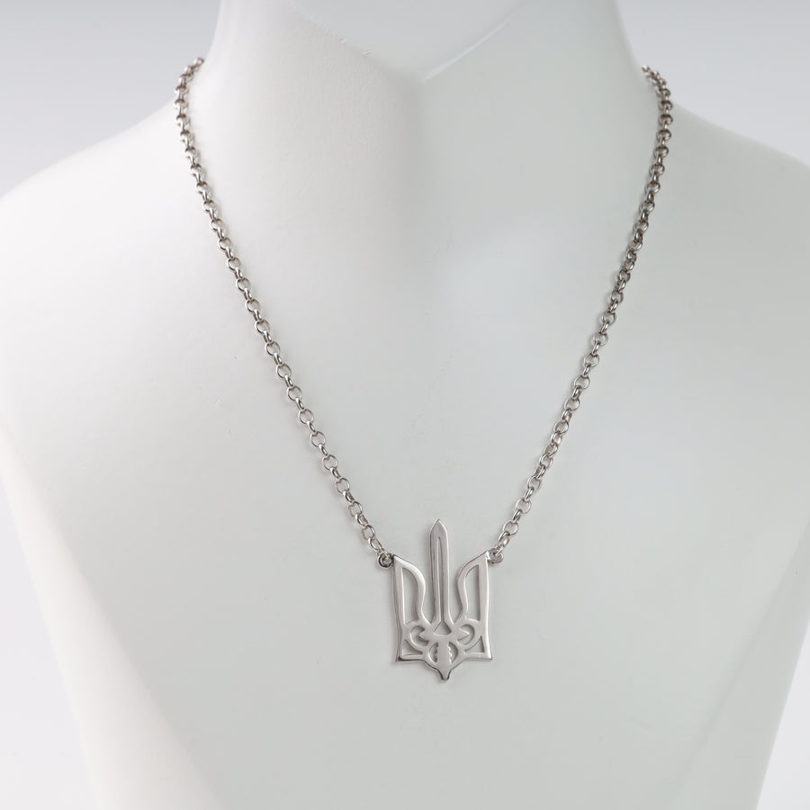 Silver chain necklace featuring a trident pendant on a display.