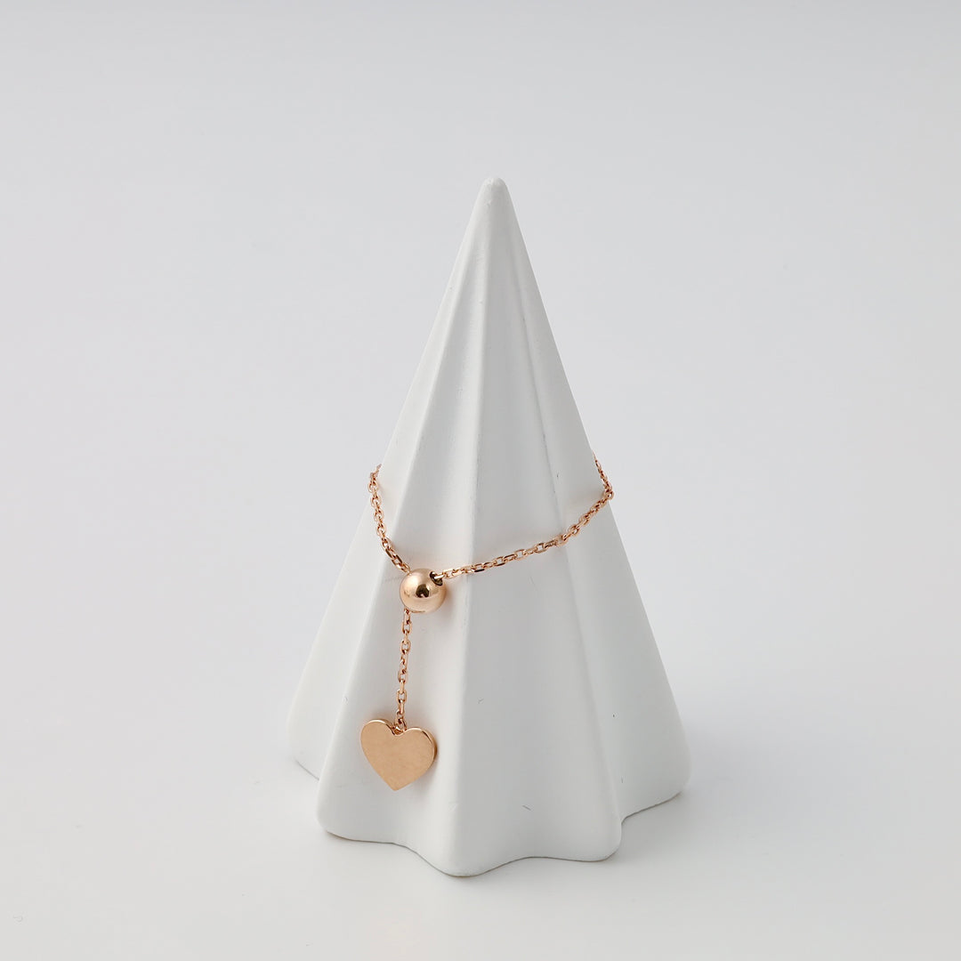 14k gold bracelet with dangling heart charm on display cone, romantic gold heart jewelry gift, Ukrainian Jewelry.