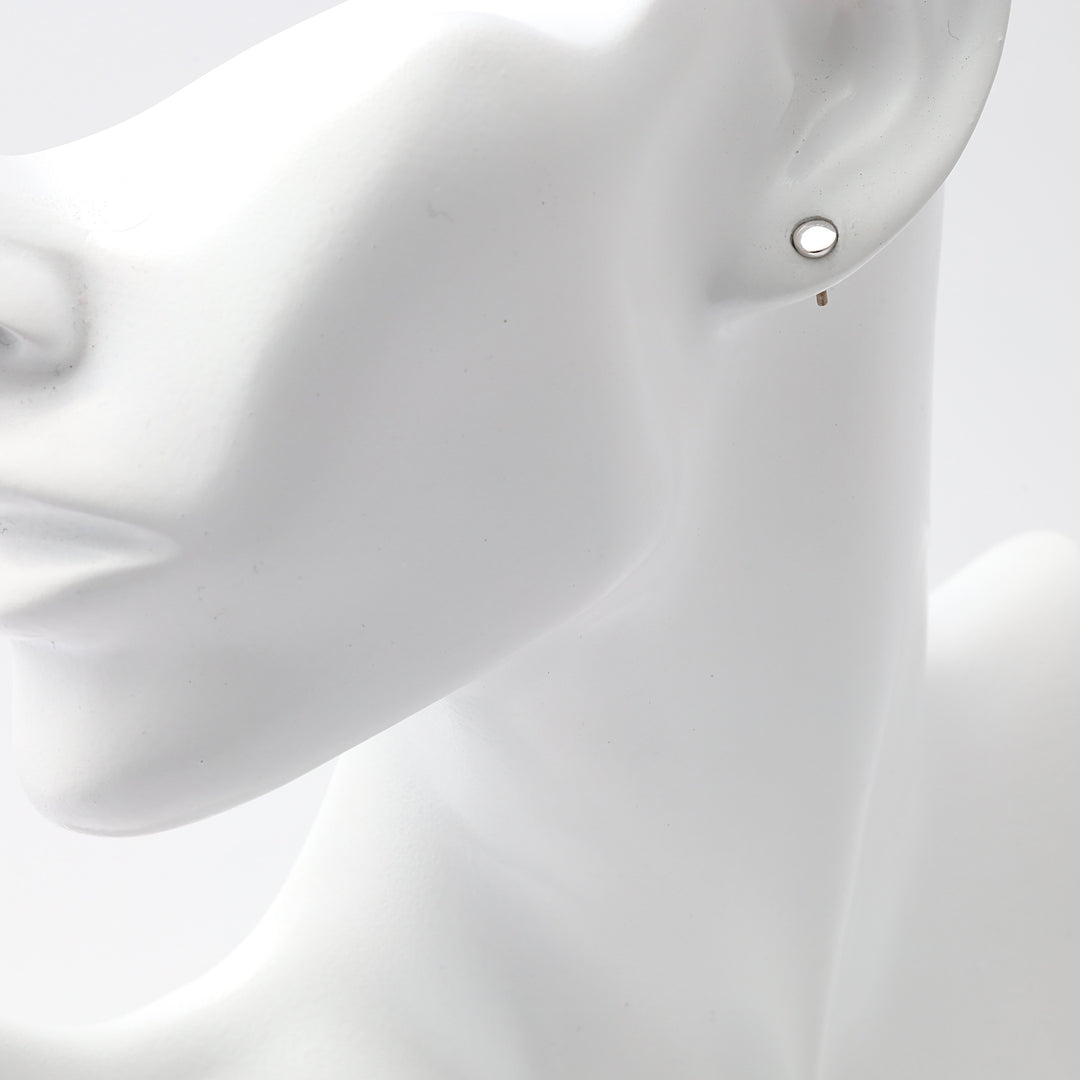 Single sterling silver open circle stud earring on mannequin ear, minimalist Ukrainian Jewelry, silver stud earrings for women.