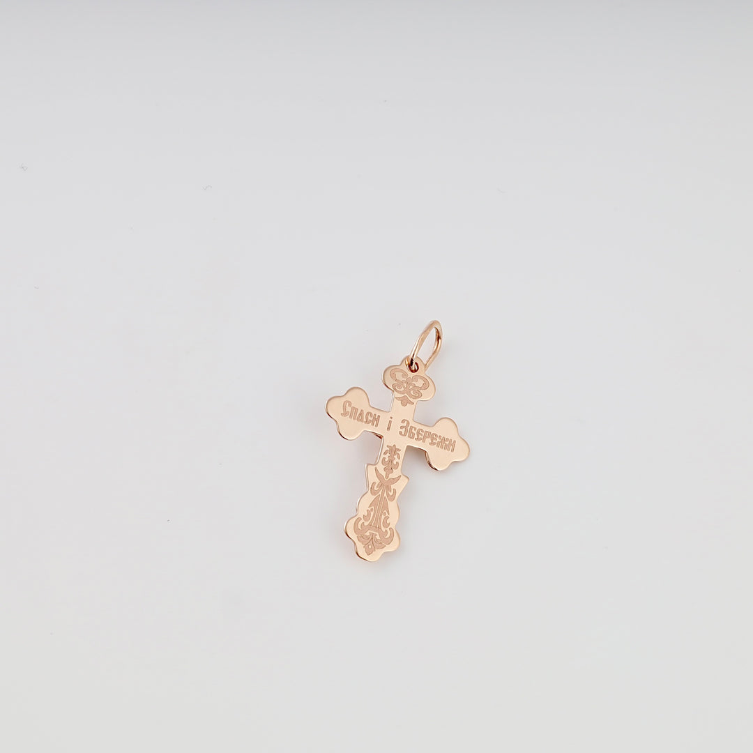 Rose gold 14k gold cross pendant with engraved Orthodox motif on white background, Ukrainian Jewelry for Christian necklace shoppers.