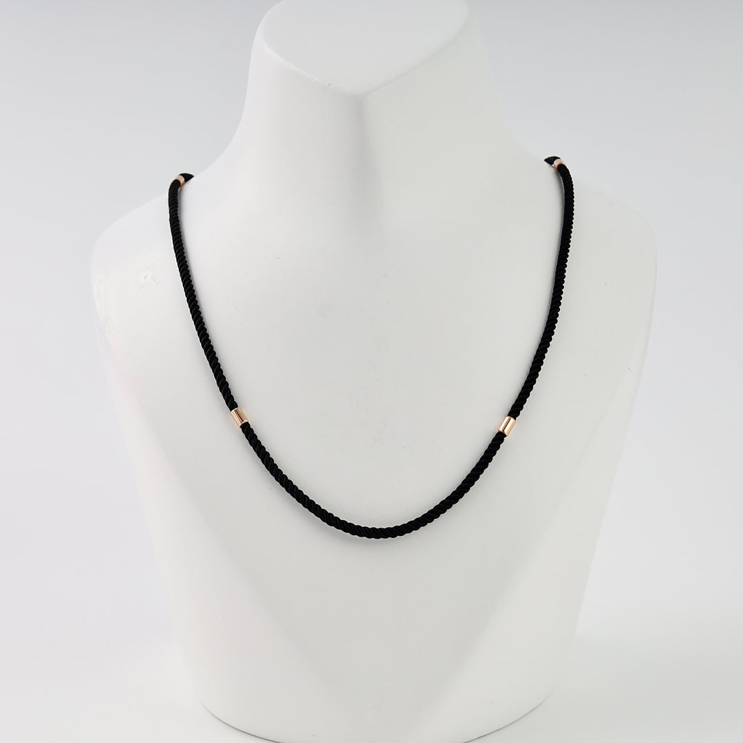 Black cord necklace with small 14k gold tube accents on display bust, minimalist Ukrainian Jewelry, simple gold chain necklace.