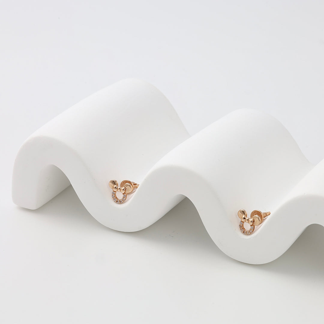 Pair of small gold stud earrings with circular motif and crystals on white display, Ukrainian Jewelry, minimalist gold earrings gift.