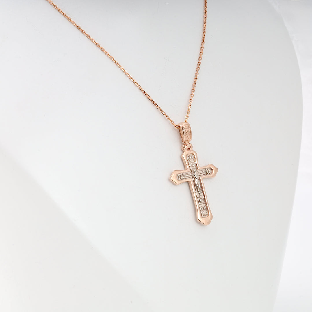 Rose gold chain necklace with an engraved Orthodox cross pendant displayed on a white bust.