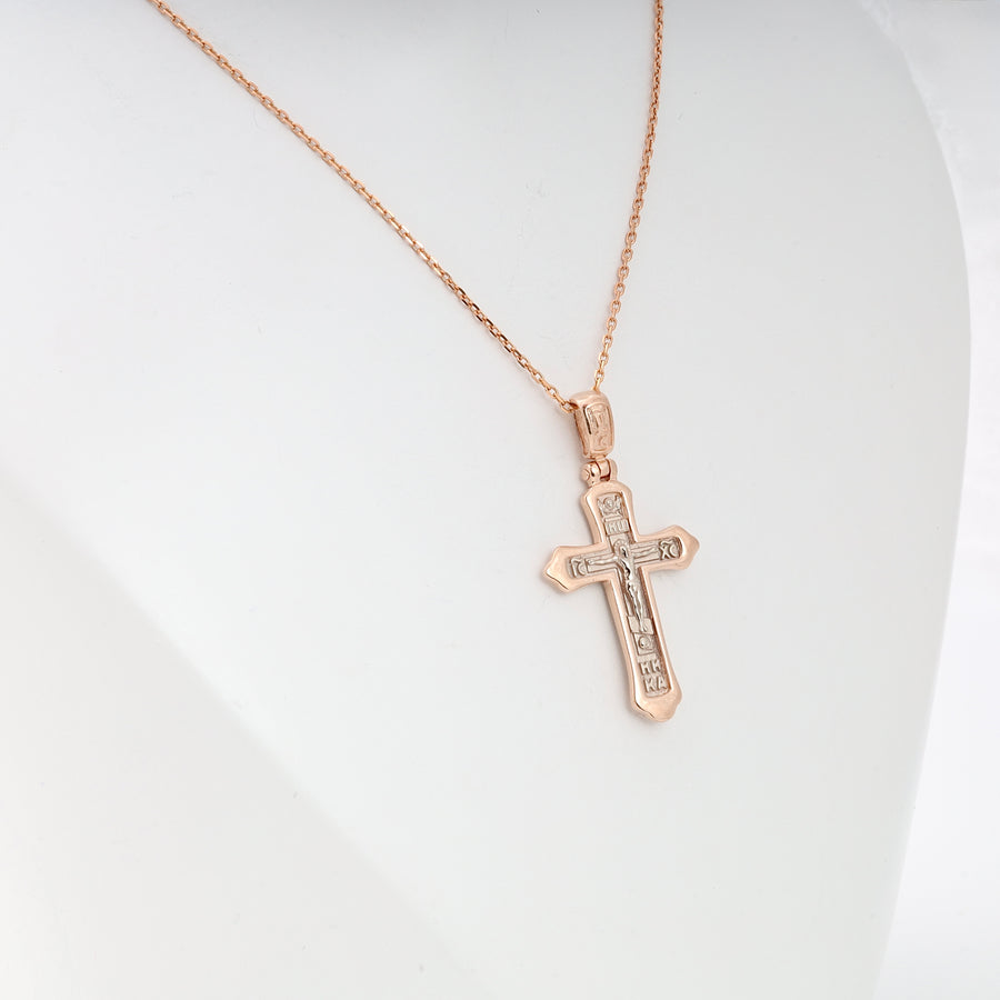 Rose gold chain necklace with an engraved Orthodox cross pendant displayed on a white bust.