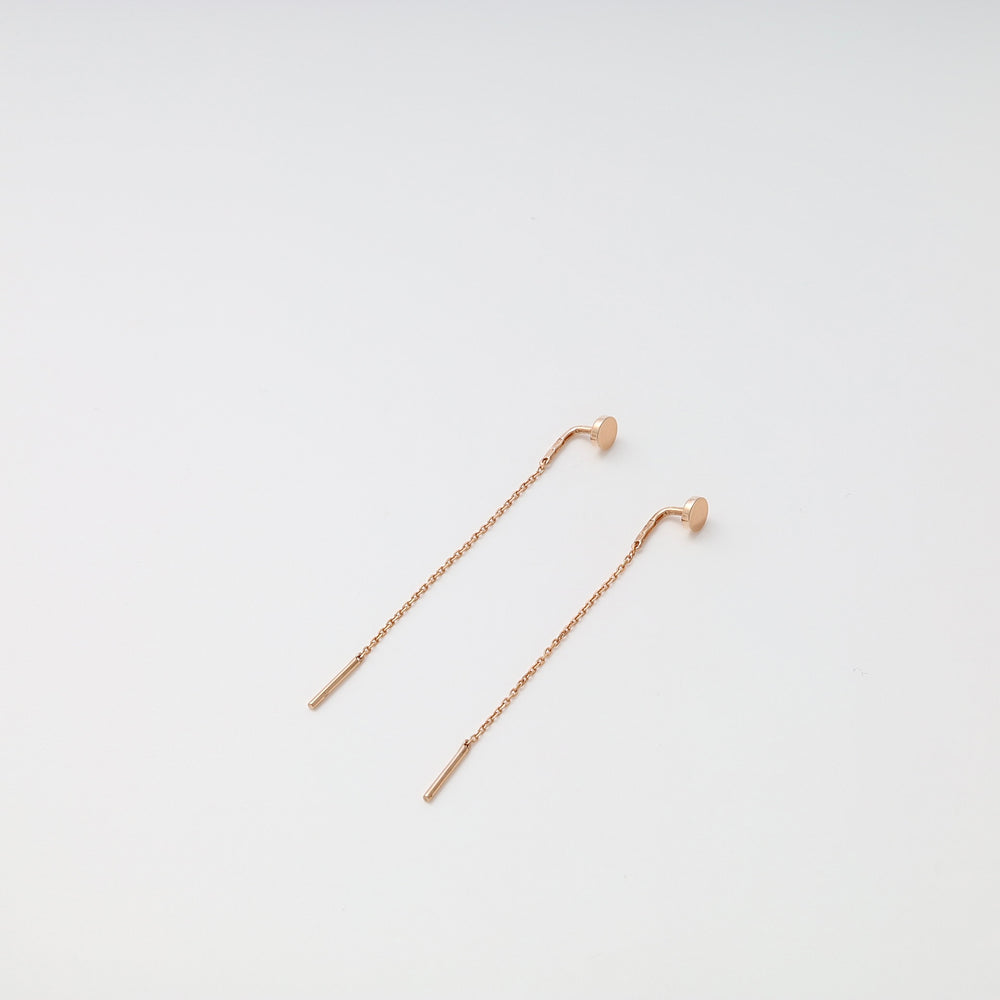 Pair of rose gold chain threader earrings with bar ends displayed on a white background.