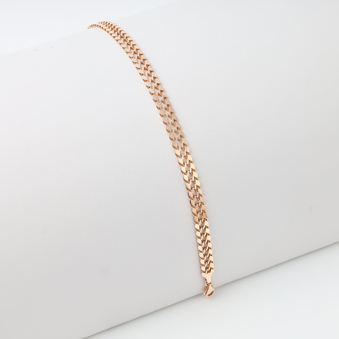 Rose gold curb chain 14k gold bracelet displayed on a white roll, minimalist Ukrainian Jewelry, simple gold chain bracelet.